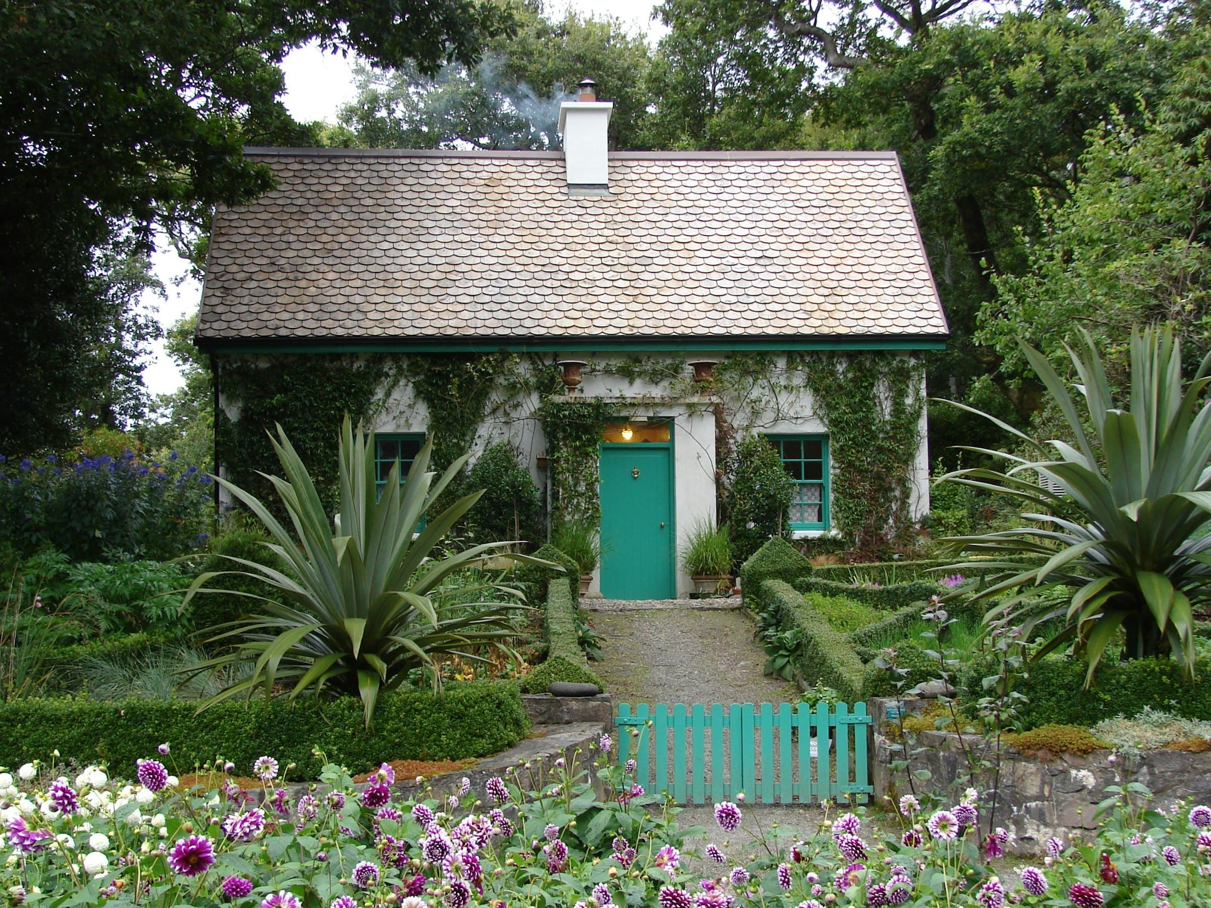 Cottage home with classic picket fence and manicured garden