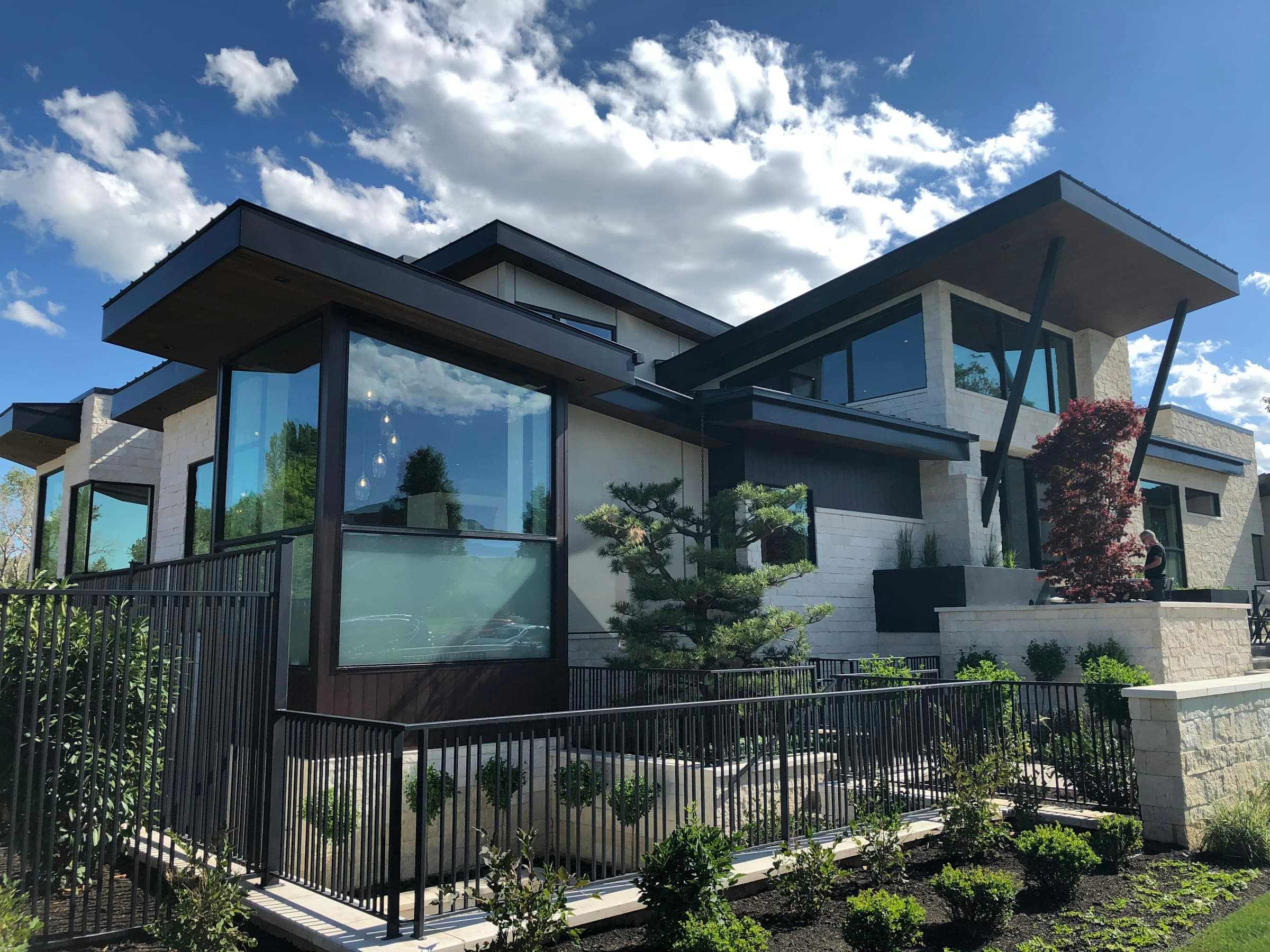 Modern home with iron property fence and considered landscaping